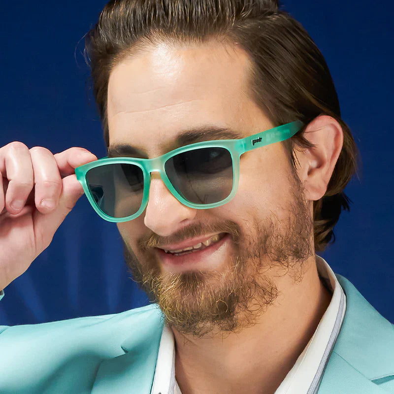 Fit and style showcase of mint green square-shaped sunglasses with gradient lenses.