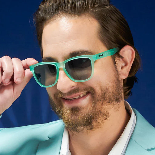 Fit and style showcase of mint green square-shaped sunglasses with gradient lenses.